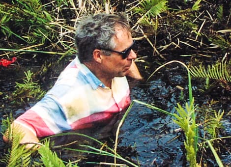 Don Price chest high in creek water.